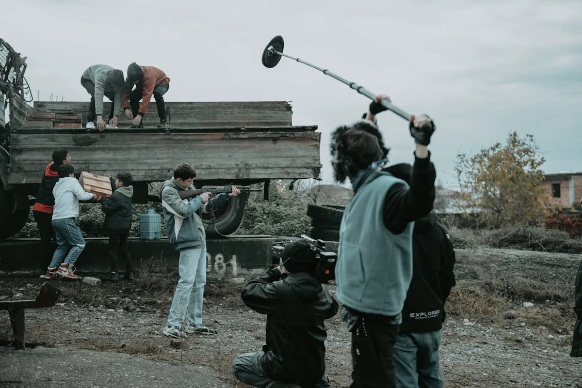 Film students hands-on with camera and sound equipment on a real production set